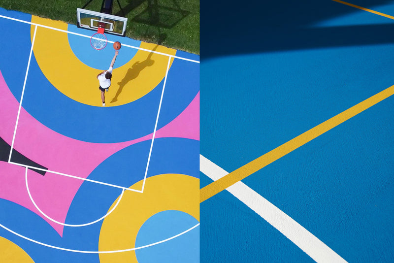 Acrylic hard court for basketball and netball with vibrant blue, yellow, and pink design.