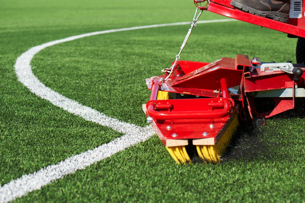 Synthetic turf maintenance machine cleaning artificial grass sports field