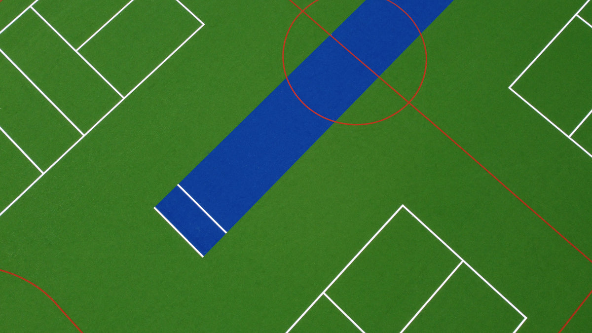 Aerial view of synthetic multi-sport turf with pickleball, soccer, and playground markings.